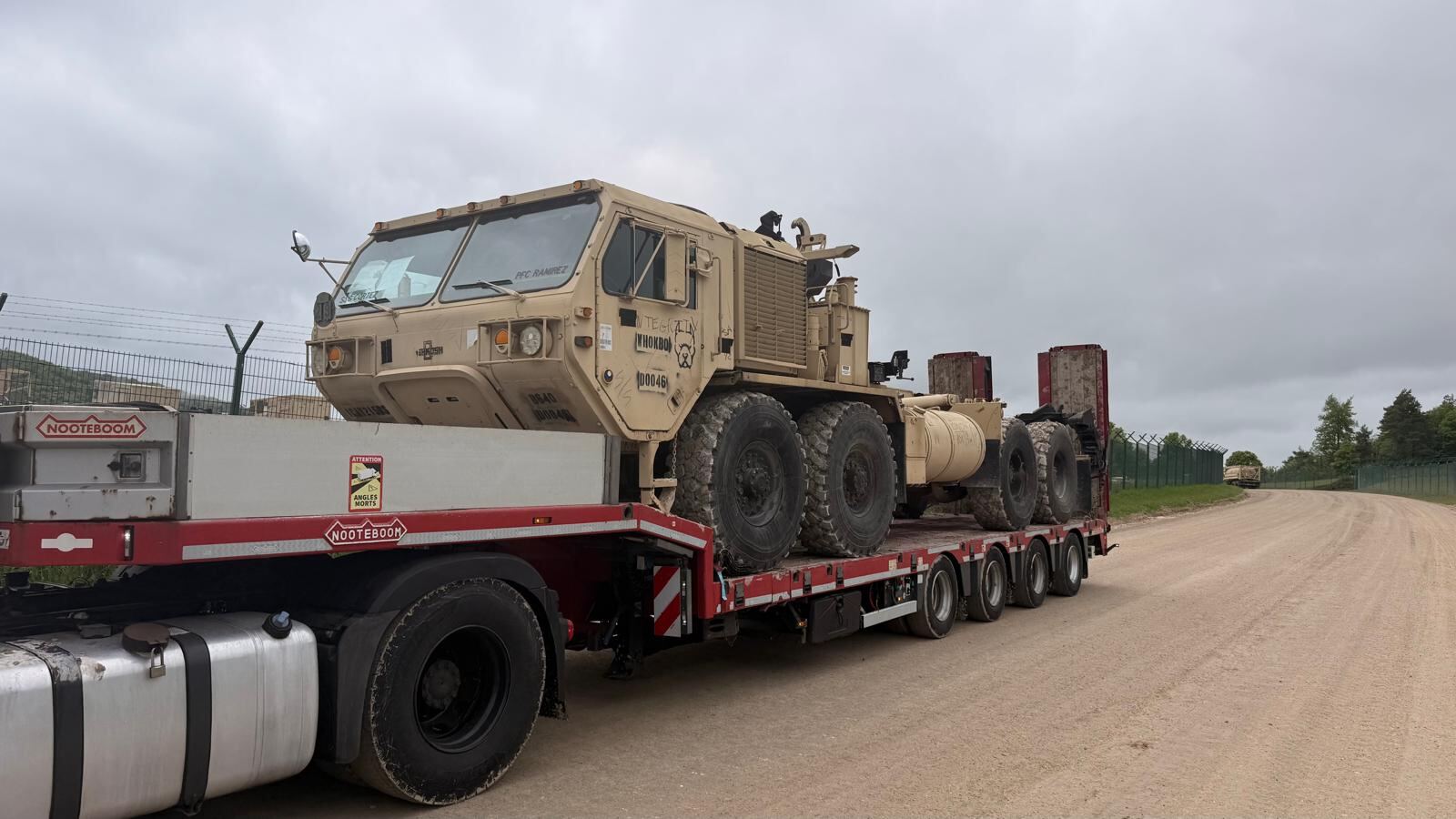 Heavy tactical truck on a lowloader in a vehicle yard